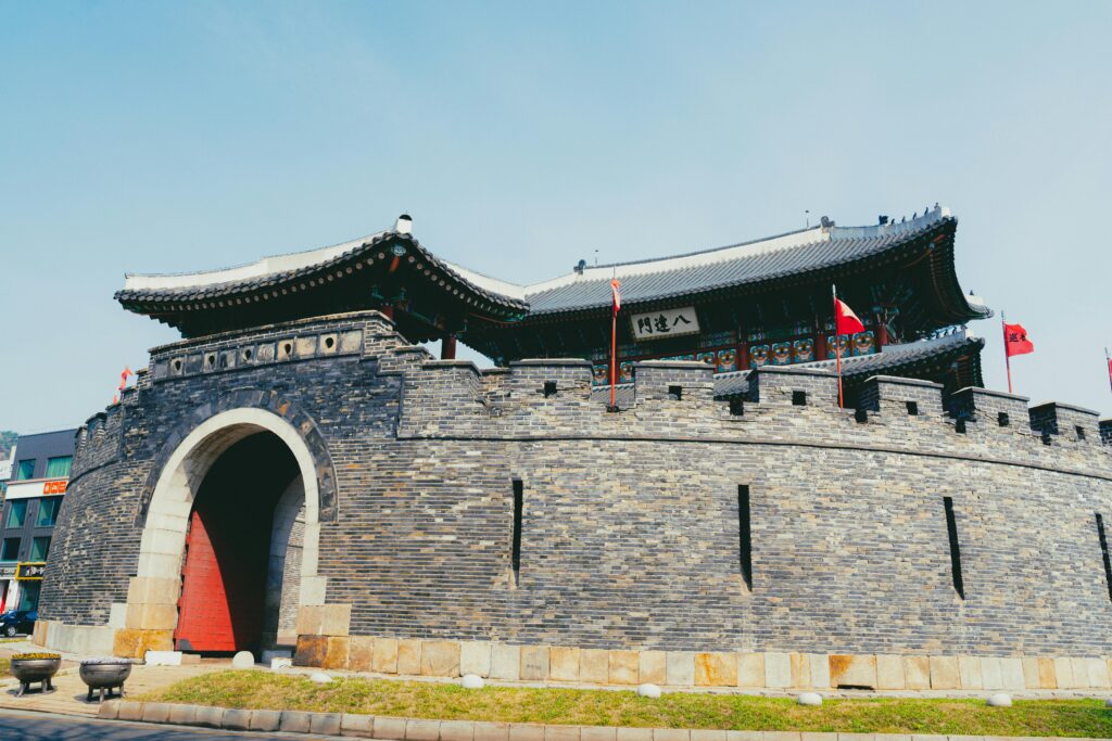 Vivid view of the Hwaseong Fortress in Suwon, showcasing traditional Korean architecture under a bright sky.