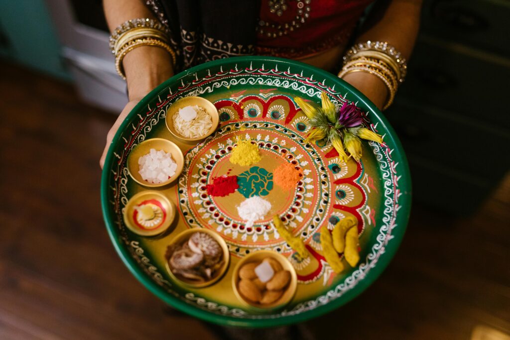 Vibrant Indian thali with spices and offerings for festive celebrations like Diwali.
